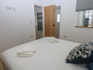 A bedroom with a bed and towels on the bed at Beudy