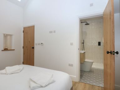 A bathroom with a shower and toilet at Beudy