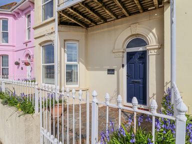A house entrance with blue door and flowers at Sea Lovers in Exmouth