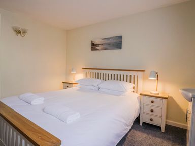 A bedroom with a bed and bedside lamps at Sea Lovers in Exmouth