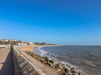 A beach view with a path and buildings at Sea Lovers Exmouth