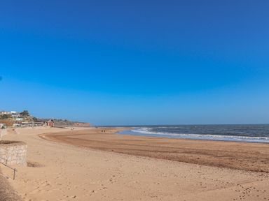 A beach scene with sand and water at Sea Lovers in Exmouth