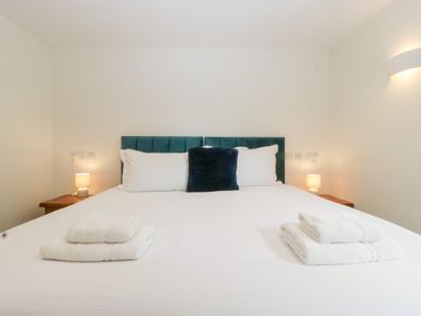 A bedroom with a bed and bedside lamps at Hidden Well in Aust