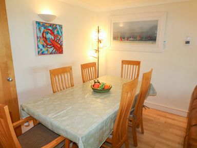 A dining room with a table and chairs at 5 Thurlestone Beach in Thurlestone