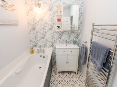 A bathroom with a bathtub and sink at A and C Lodge-Plot 21 Armathwaite
