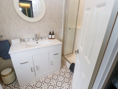 A bathroom with a sink, shower, and mirror at A and C Lodge-Plot 21 Armathwaite