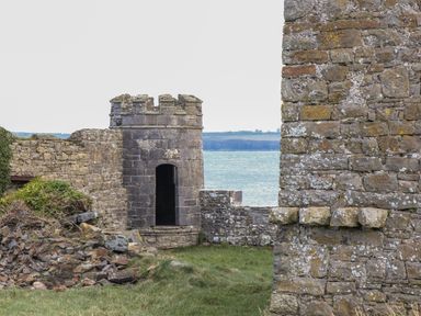 Stone walls and tower overlooking the sea at The Boathouse in Carrigaholt County Clare