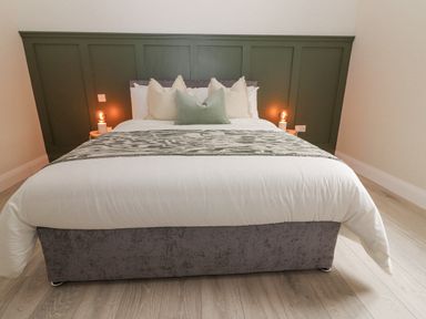 A bedroom with a bed pillows and bedside lamps at Curhoor Near Loughrea County Galway