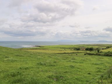 A landscape view of fields and ocean at Doonalton House in Dromore West, County Sligo