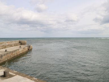 A view of a pier extending into the ocean at Doonalton House in Dromore West, County Sligo