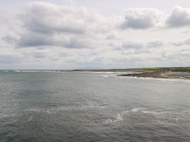 View of the ocean and shoreline with clouds in the sky at Doonalton House Dromore West County Sligo
