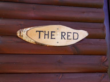 A wooden plaque with the text The Red at The Red in Llanerch Park near St Asaph