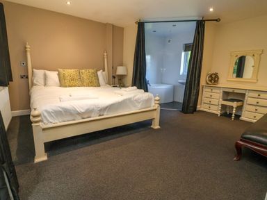 A bedroom with a bed and dresser at The Red in Llanerch Park near St Asaph