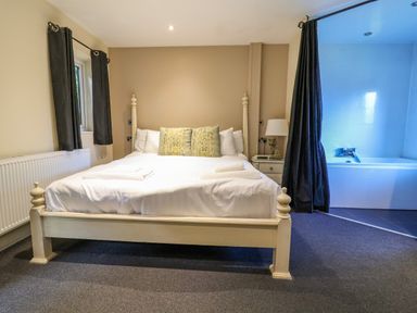 A bedroom with a bed and bathtub at The Red in Llanerch Park near St Asaph