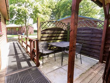 An outdoor area with a table and chairs at The Red in Llanerch Park near St Asaph