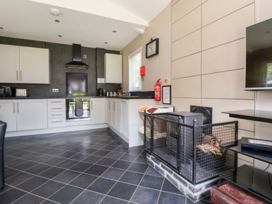 A kitchen with cabinets and an oven at The Fallows in Llanerch Park near St Asaph