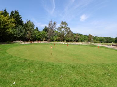 A golf putting green with flags at The Fallows in Llanerch Park near St Asaph