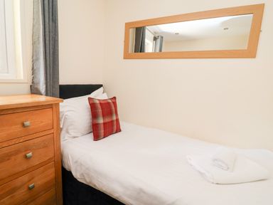 A bedroom with a bed and a bedside table at The Roe in Llanerch Park near St Asaph