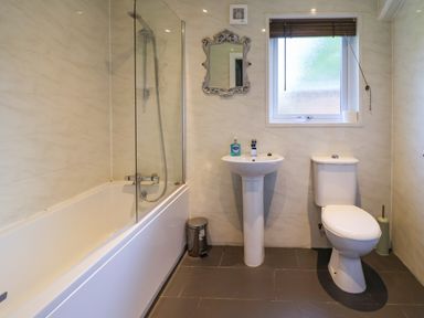A bathroom with bathtub, sink, and toilet at The Roe in Llanerch Park near St Asaph