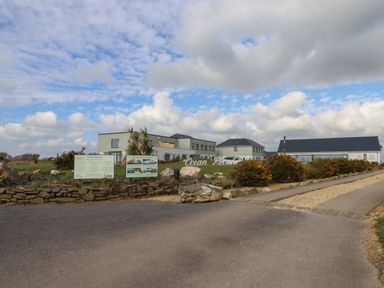 A building complex with signage and a driveway at 5 Ocean Reach in Bolberry