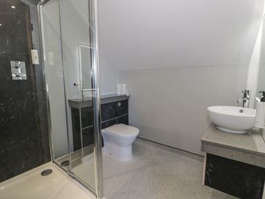 A bathroom with a shower cabin toilet and a round sink at Premier Lodge 41 in Dyserth