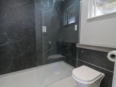 A bathroom with a walk-in shower and a toilet at Luxury Lodge 62 in Dyserth