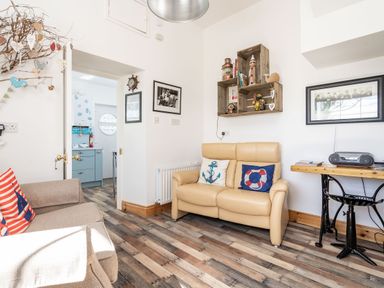 A sitting room with two sofas a wooden desk and decorative shelves at The Old Coastguard Tower Buncrana