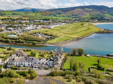 A coastal town with houses near a river and a golf course by the sea at The Old Coastguard Tower Buncrana in Buncrana County Donegal