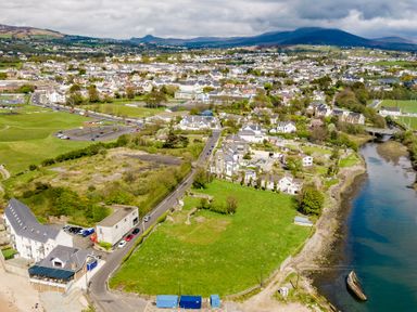 An aerial view of a town with houses roads a river green fields and distant hills at The Old Coastguard Tower Buncrana County Donegal