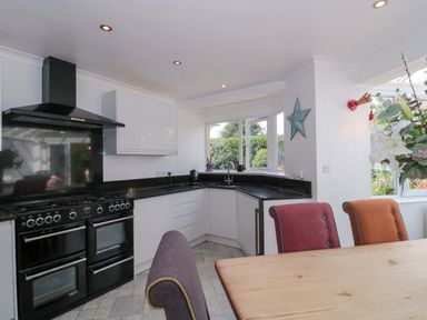 A kitchen with stove and sink at No 8 Burnham-on-Sea