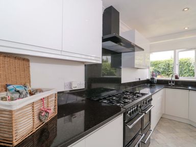 A kitchen with a black countertop and a gas oven at No 8 Burnham-on-Sea