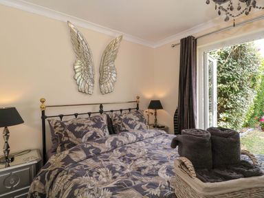 A bedroom with a bed and wall art at No 8 in Burnham-on-Sea