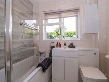 A bathroom with a bathtub and sink at No 8 Burnham-on-Sea