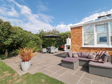 A garden with a seating area and plants at No 8 Burnham-on-Sea