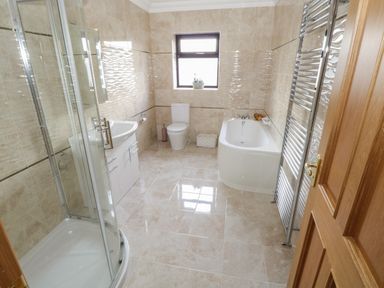 A bathroom with a shower enclosure sink toilet bathtub and towel radiator at Bunny Lane in Cloonflynn near Ballycarra County Mayo