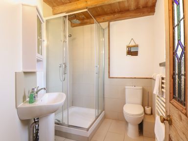 A bathroom with a shower enclosure sink toilet and towel rack at Berts Barn Mullion