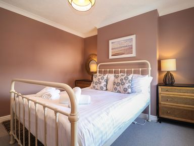 A bedroom with a bed pillow lamps and two bedside cabinets at First Light in Pakefield near Lowestoft