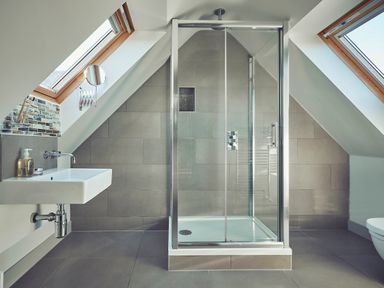 A bathroom with a shower enclosure a sink a wall-mounted faucet and two skylight windows at Craster Reach in Craster