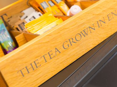 A wooden box with various tea bags and labelled the tea grown in england