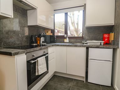 A kitchen with appliances and countertops at Tolroy Manor Holiday Park in St Erth Praze near Hayle