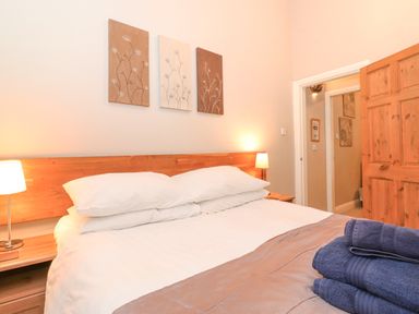 A bedroom with a double bed and two bedside lamps at Myrtle Cottage in Windermere