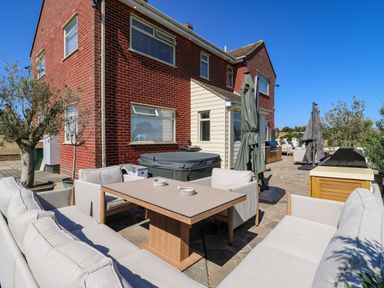 An outdoor area with furniture and a barbecue grill at The Farmhouse in St. Osyth