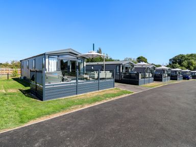 A row of holiday homes with decking at Lakewood Plot 2 St. Osyth