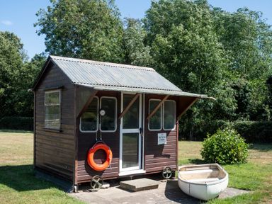 A shed with a life ring and a small boat at Lakewood Plot 2 St. Osyth