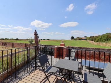 An outdoor area with seating and a view at Waverley Cottage in Kilnsea near Easington, Hull