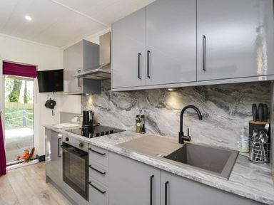 A kitchen with modern appliances and countertop at Squirrels Lodge in South Molton