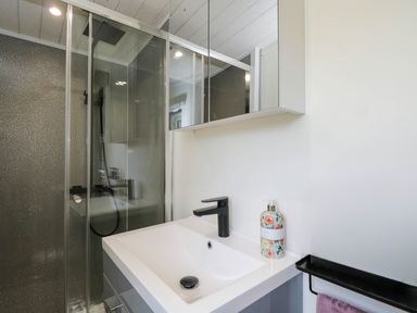 A bathroom with a sink and shower at Squirrels Lodge in South Molton