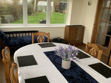 A dining room with a table and chairs at Woods Cottage in Usk