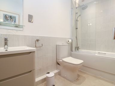 A bathroom with a sink, toilet, bathtub, and shower at Mariners Watch in Carbis Bay