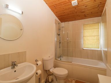A bathroom with a sink toilet and bathtub with shower at Lodge 16 Whitsand Bay near Millbrook